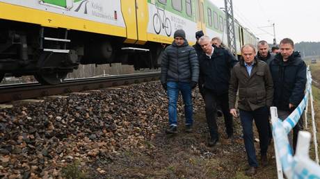 Poland Prime Minister Donald Tusk and Polish Interior Minister Marcin Kierwinski inspect the damaged railway tracks on the Warsaw-Lublin route in Poland on November 17, 2025.